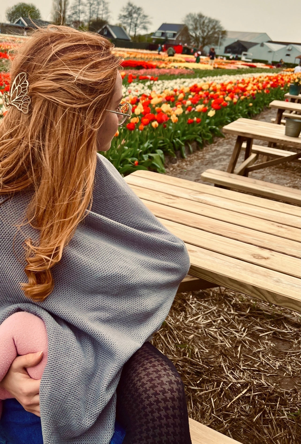 Mum breastfeeding confidently in public using the Momcho nursing cover.